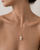 Josephine 18k yellow gold pearl pendant with two freshwater pearls, worn on a fine gold chain.
