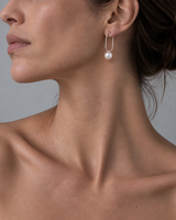 Model wearing ORFÉLIE Emilie designer pearl hoop earrings in sterling silver.