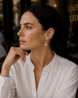 Woman wearing Emilie designer pearl hoop earrings in sterling silver